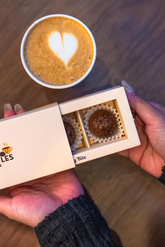 Unboxing a Happy Truffles box with a latte